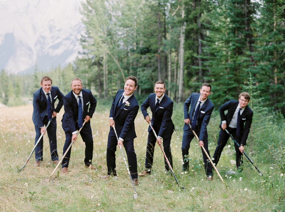 groomsmen in navy suits hockey photo | Banff springs wedding photographers | fairmont banff rocky mountain wedding | Justine Milton fine art film Photography