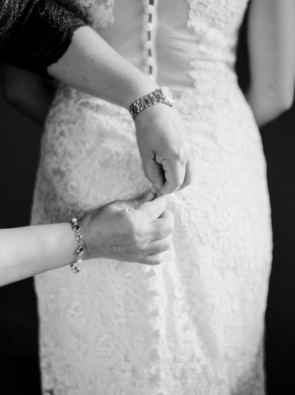 Banff Wedding Photographers | Bride getting ready button and lace dress | Justine Milton fine art film photographers