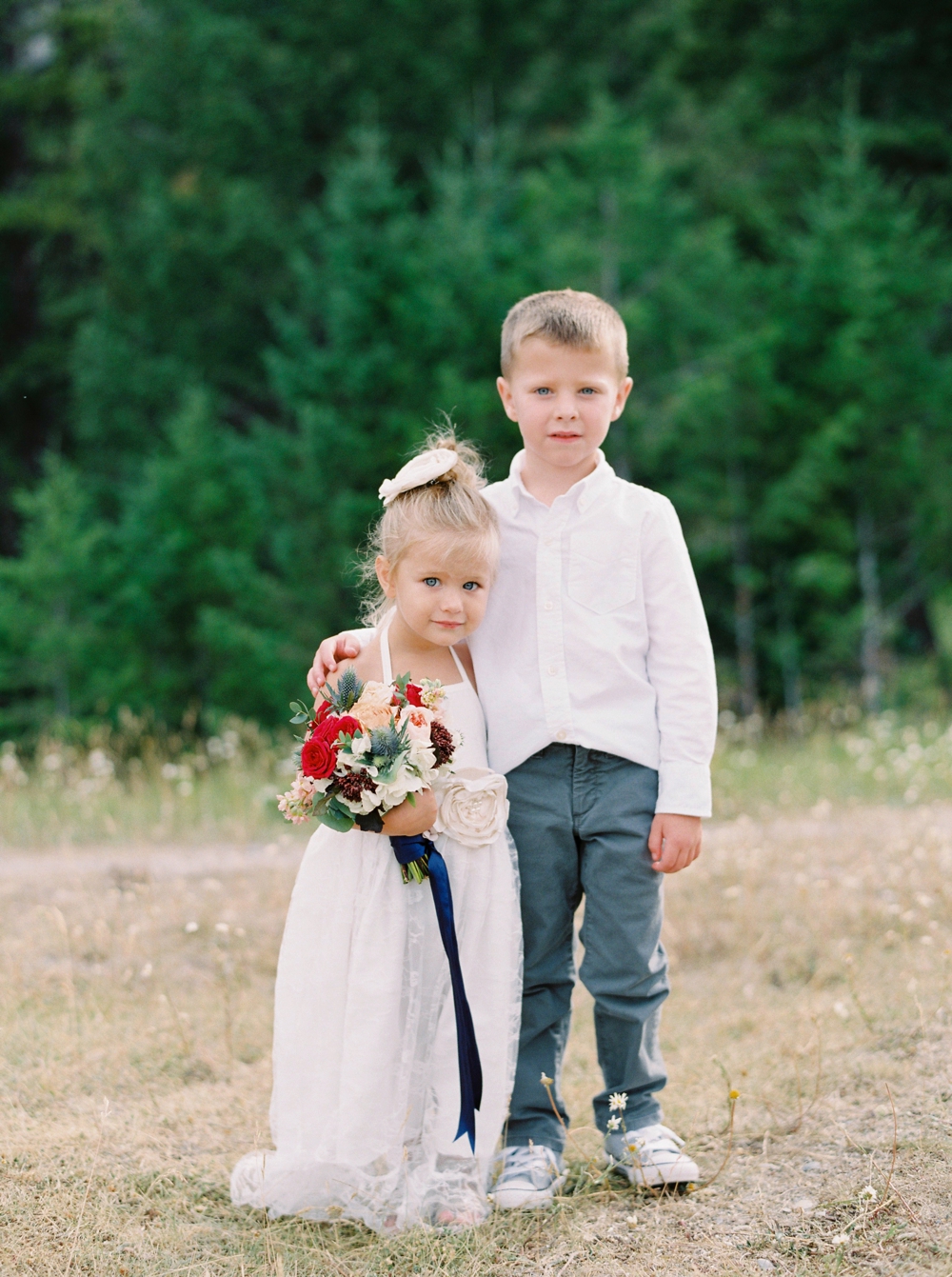 Banff Wedding Photographers | Banff tunnel mountain reservoir | wedding ceremony decor brightly colored florals | flower girl and ring bearer | Justine Milton fine art film photographers