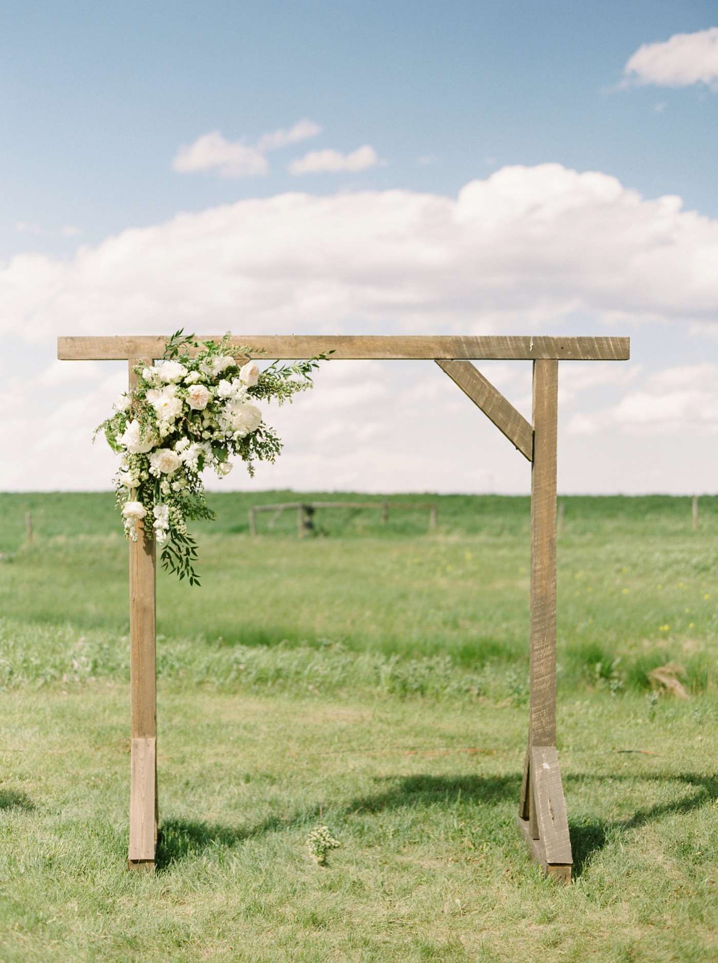 Calgary wedding photographers | The Gathered Farm Wedding | Justine milton fine art film photographer | outdoor farm wedding ceremony rustic arch structure