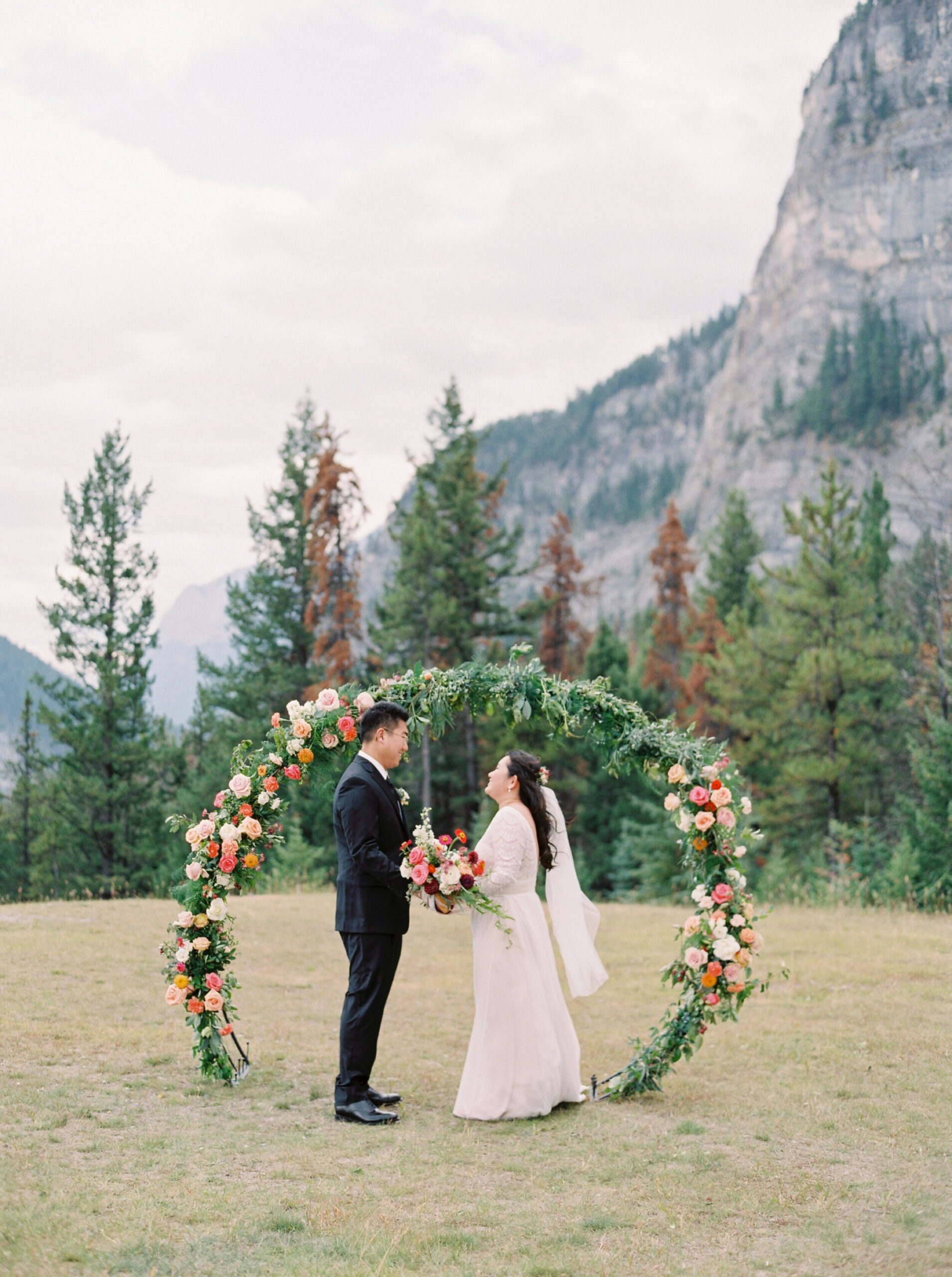  Banff wedding photographers | Justine milton photography | fine art film destination wedding photographer | Banff elopement floral arch ceremony decor 