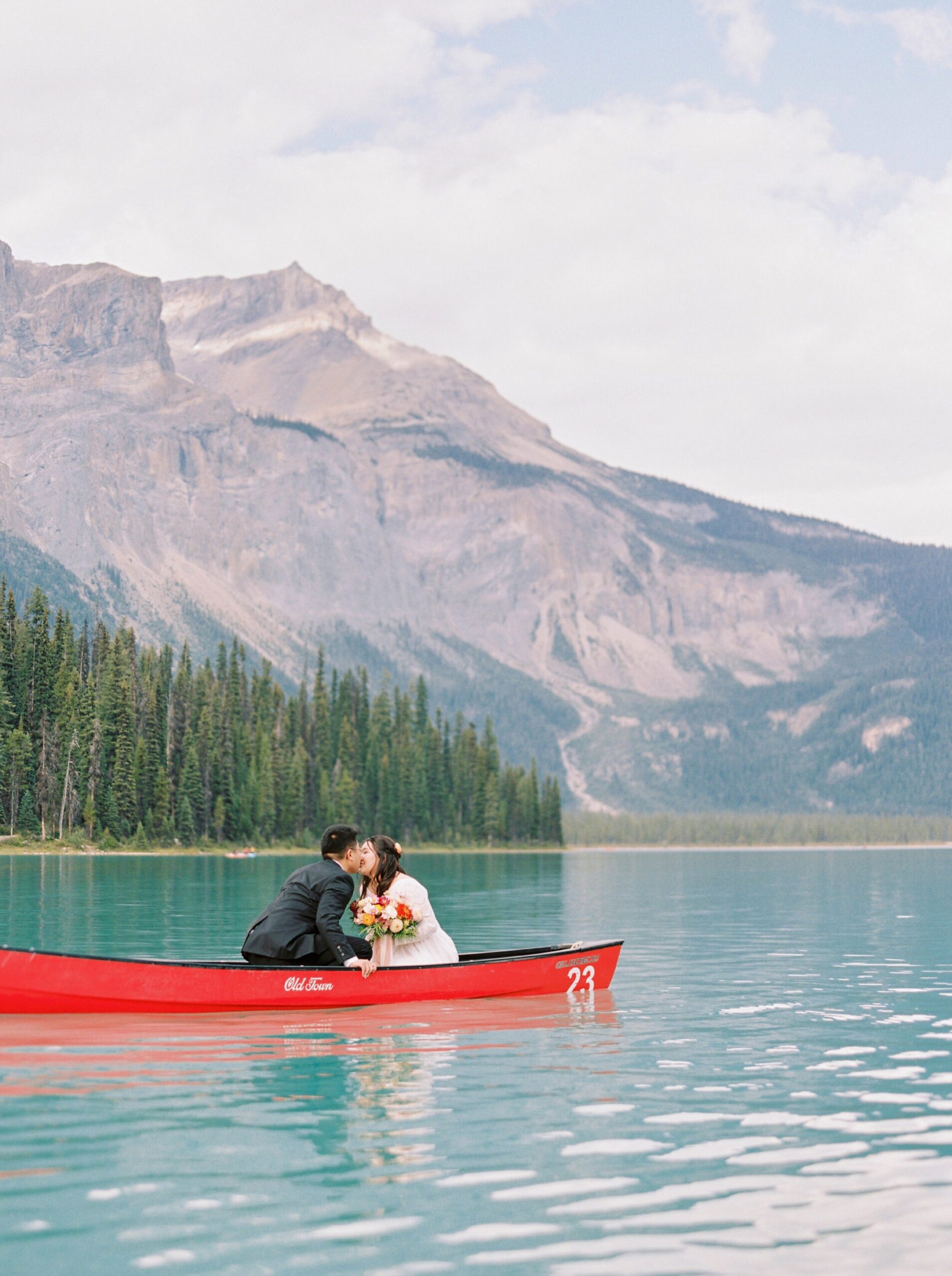  Banff wedding photographers | Justine milton photography | fine art film destination wedding photographer | Emerald Lake Lodge Elopement bride and groom in a canoe 