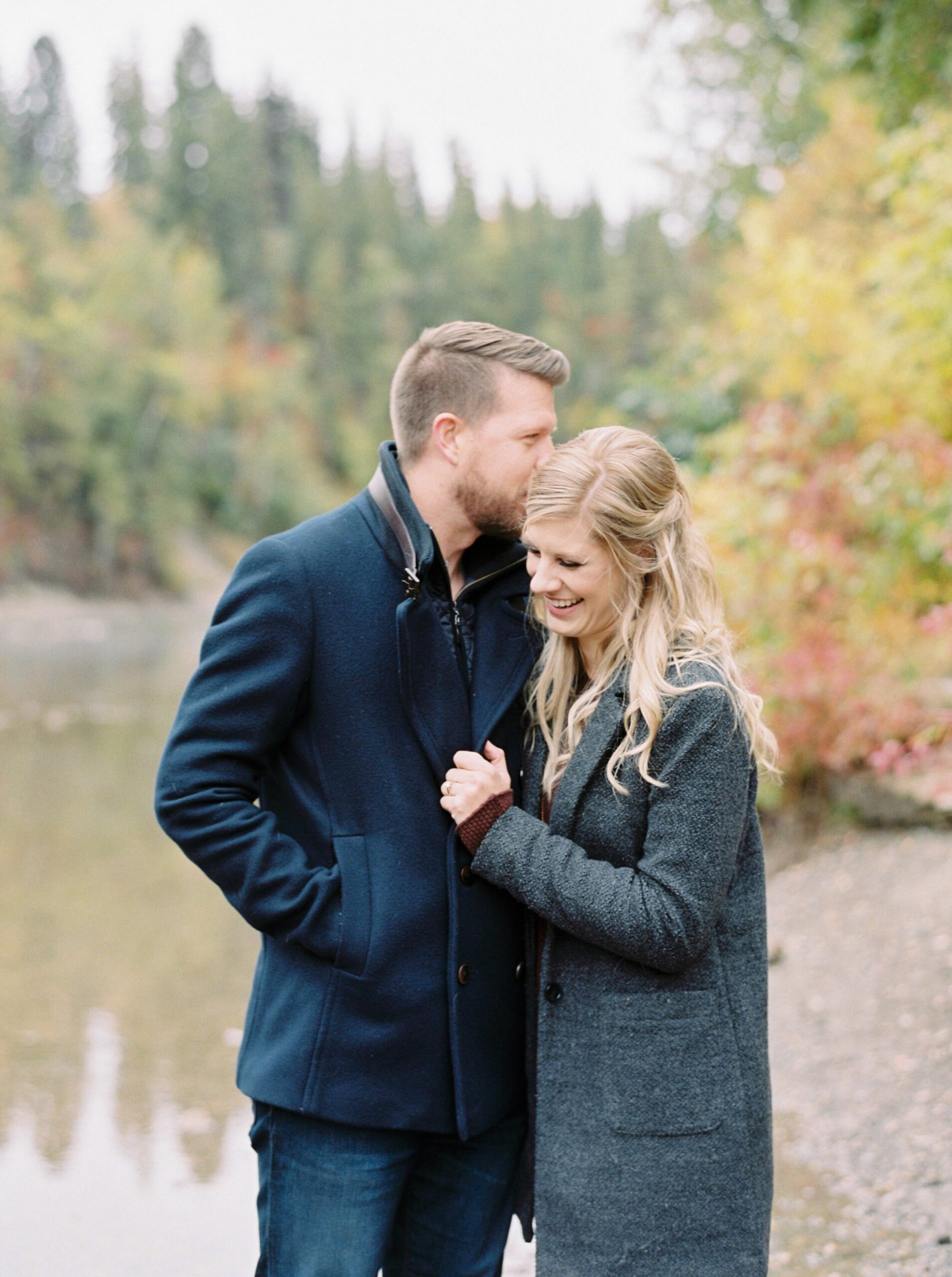  perfect fall colors for calgary river side engagement sesson with dogs | couples pose ideas for engaement photos | fine art film photographers 