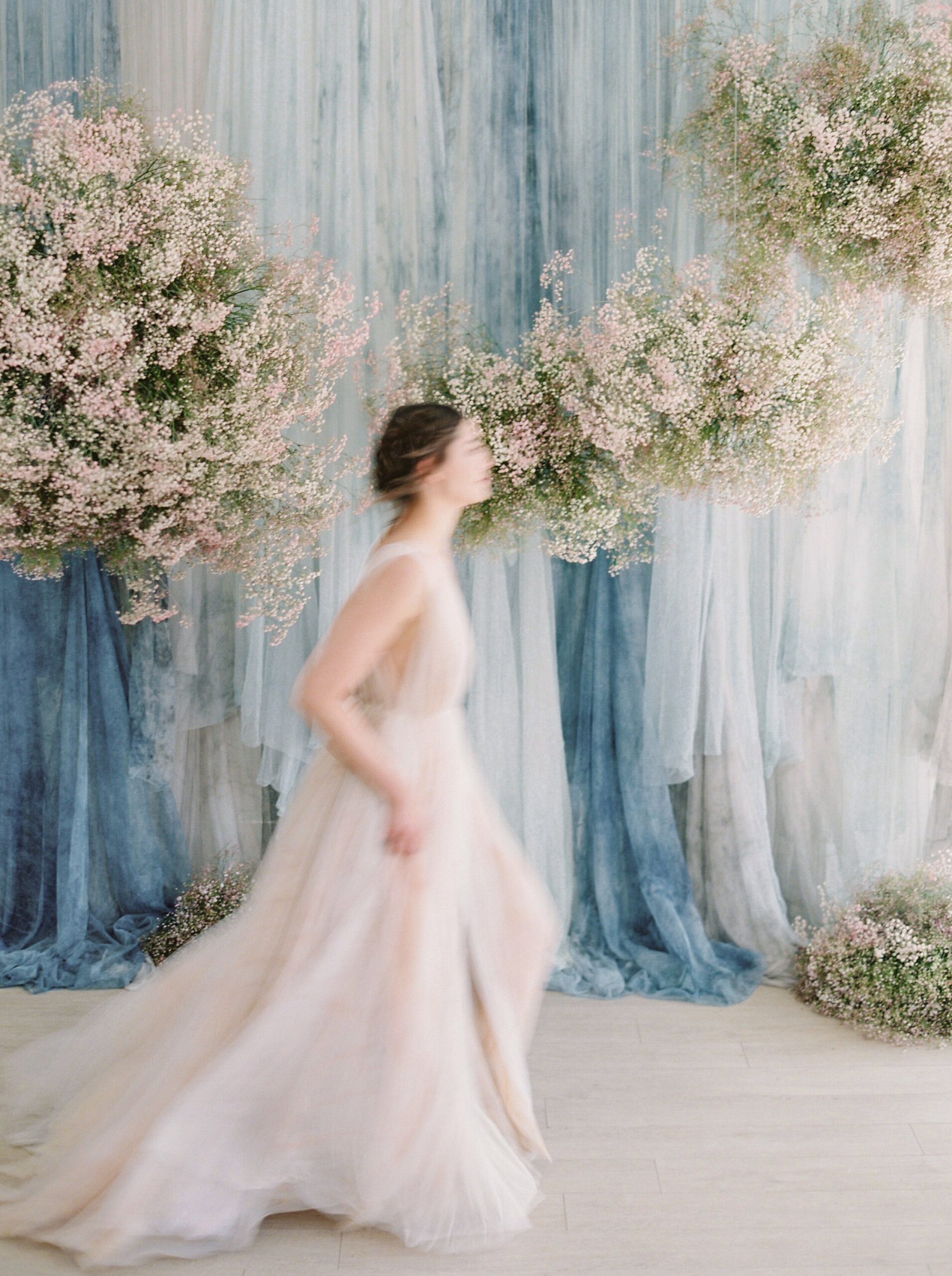  babys breath floral installation with blu efabric watercolor backdrop | fashion wedding editorial | poofy tulle skirt and wedding dress | fine art film photographer Calgary wedding photographers Justine Milton 