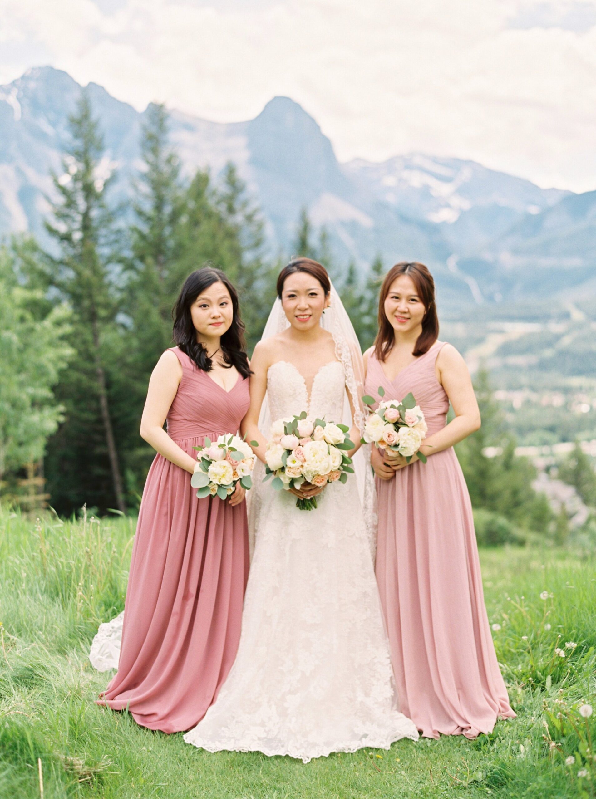  wedding party with mix matched blush pink dresses and navy suits and vests | silvertip canmore wedding photographers 