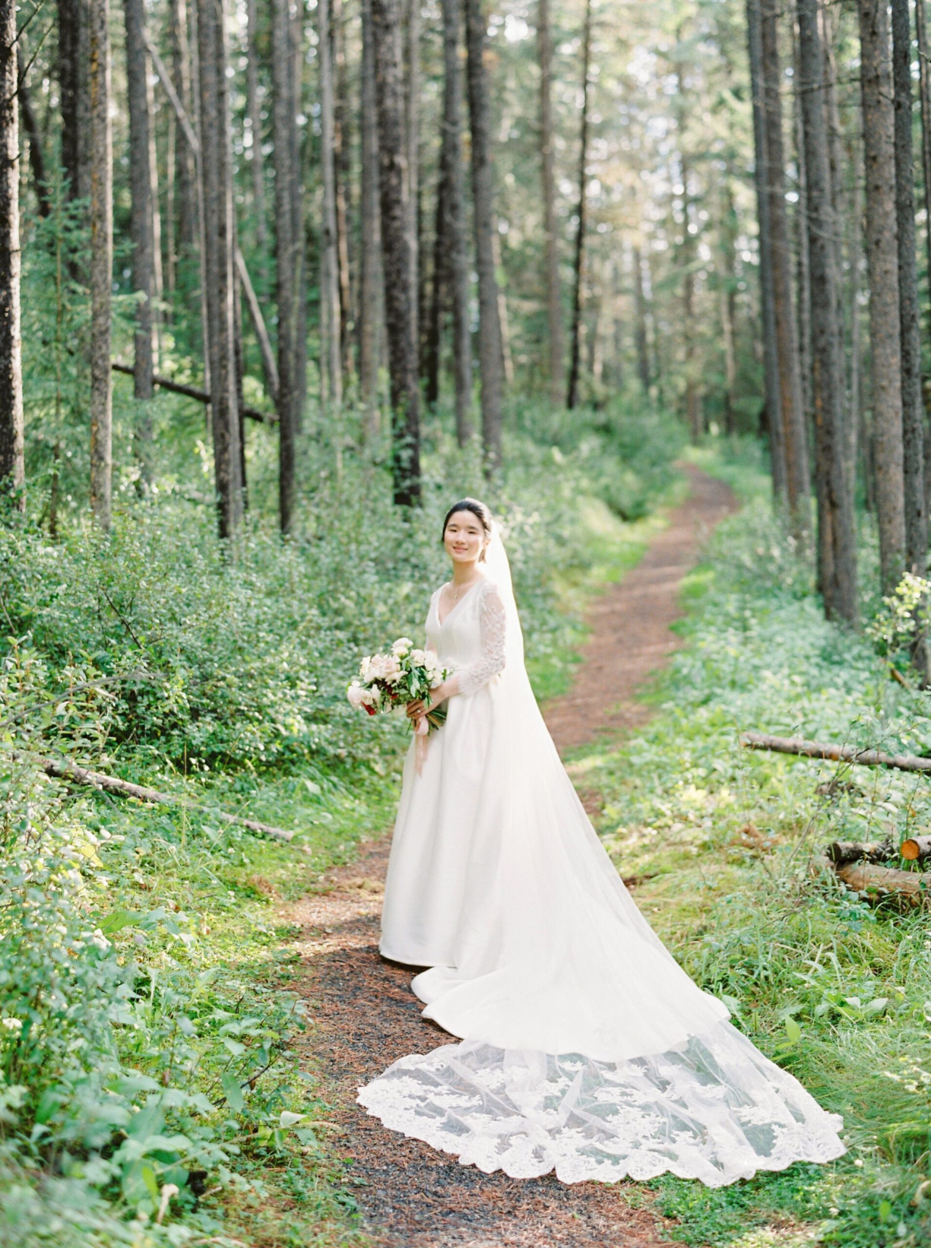  Forest mountain wedding portraits cathedral lace veil | Fairmont Banff Springs hotel wedding photographers | fine art film photography | portra 400 