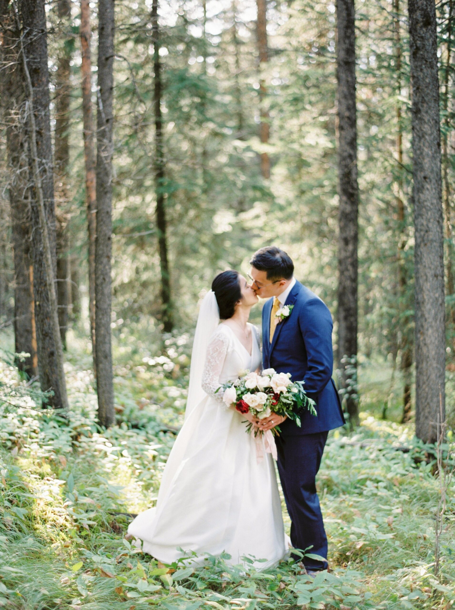  Forest mountain wedding portraits cathedral lace veil | Fairmont Banff Springs hotel wedding photographers | fine art film photography | portra 400 