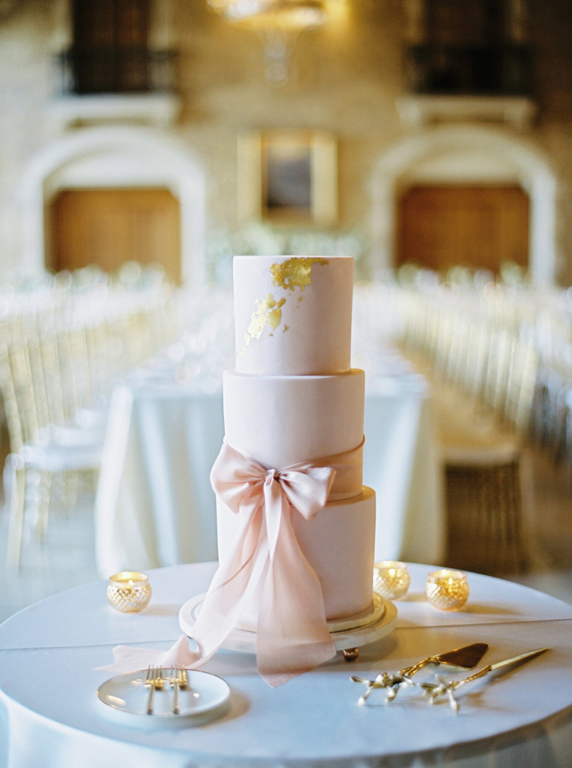  3 tiered pink and gold cake with giant bow | Fairmont Banff Springs hotel wedding photographers | fine art film photography | portra 400 