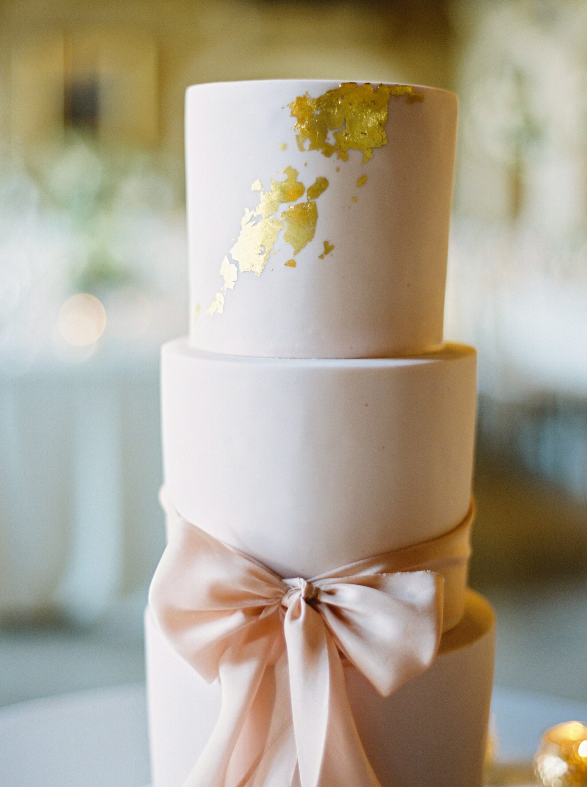  3 tiered pink and gold cake with giant bow | Fairmont Banff Springs hotel wedding photographers | fine art film photography | portra 400 