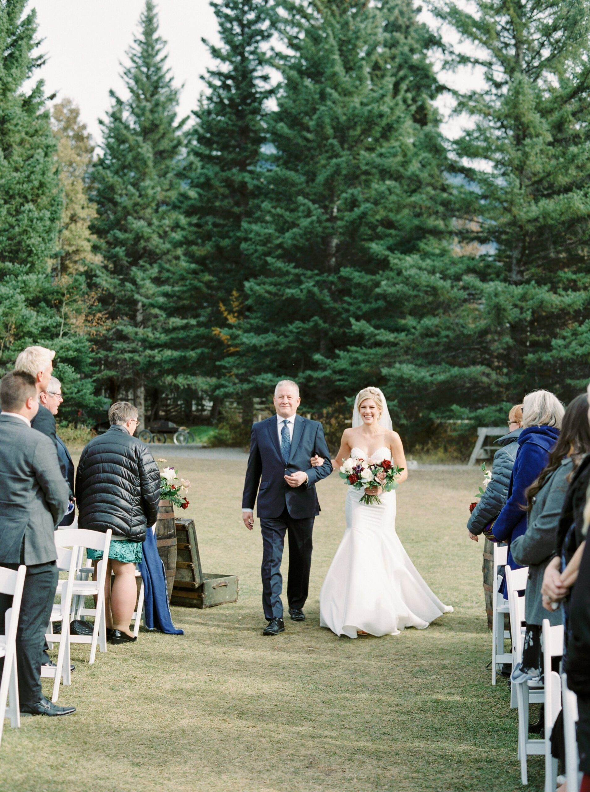  Outdoor mountain ceremony with a triangle floral arch | Cornerstone Theater & Canmore Ranch Wedding Photographers 