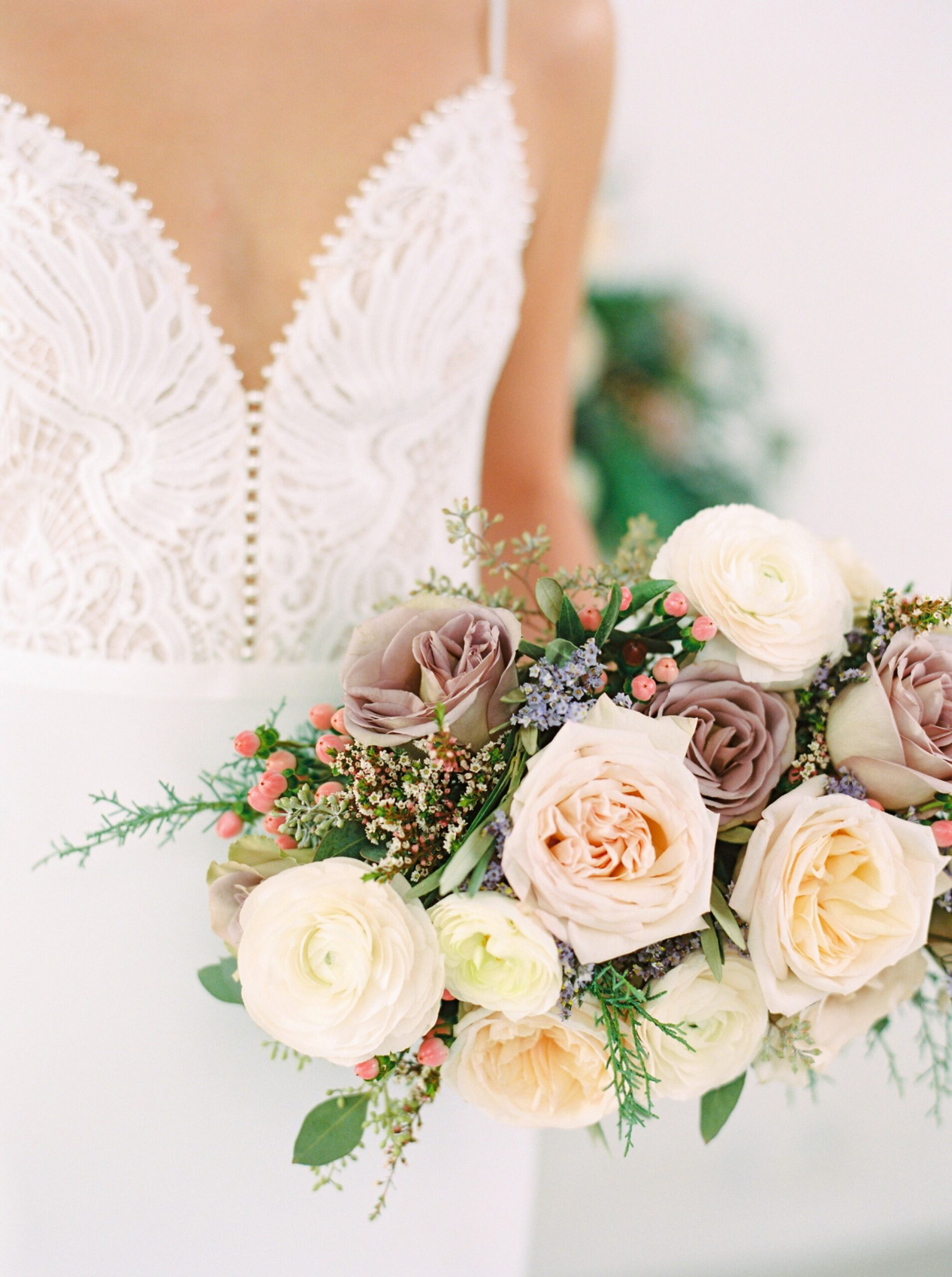  wedding dress inspiration | fine art flower installation with greenery above fireplace | modern bridal bouquet with dusty pinks and roses 