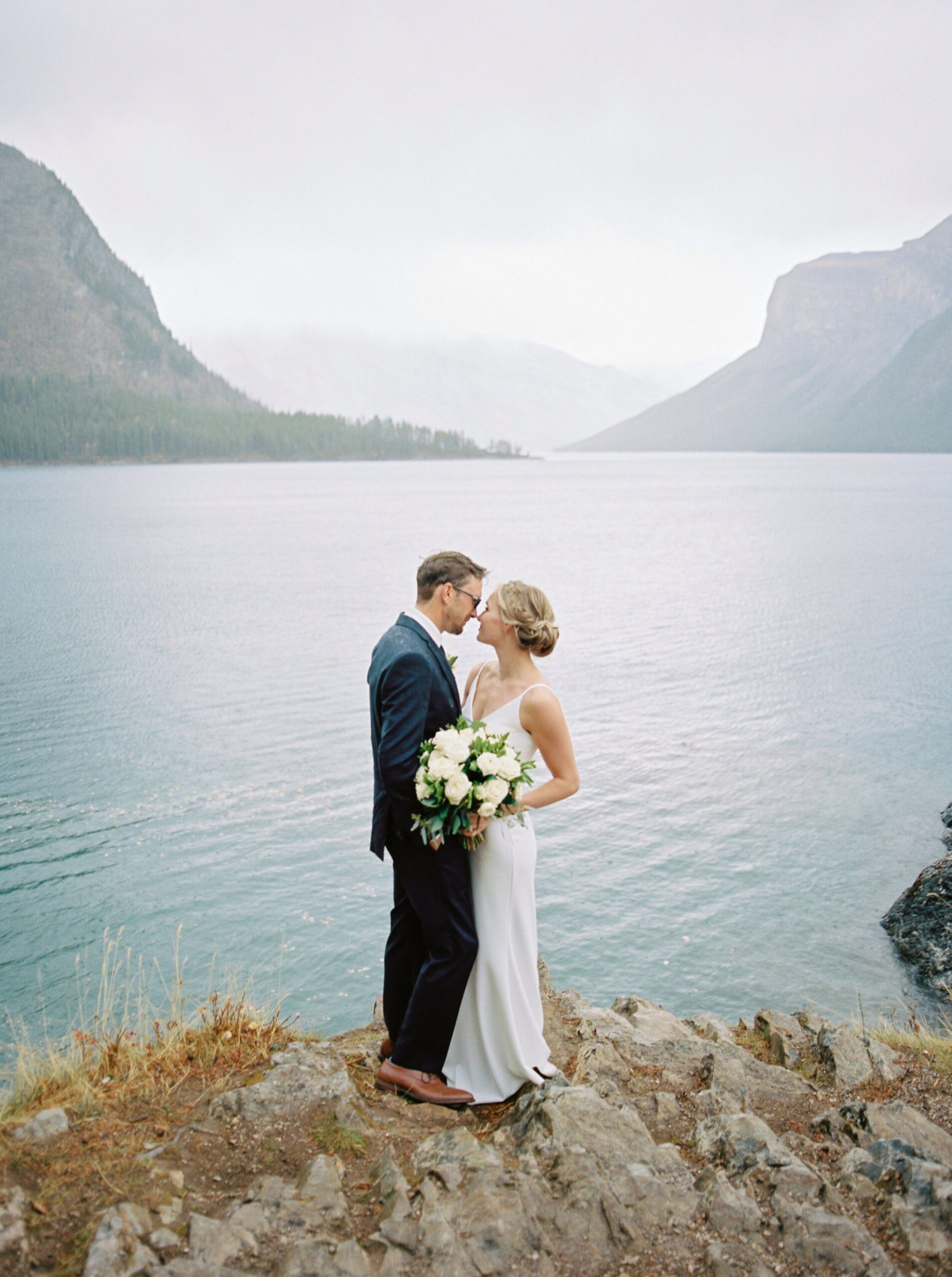  Bride and groom portraits in the pouring rain | Banff Springs Hotel Vow Renewal Wedding Photographers 