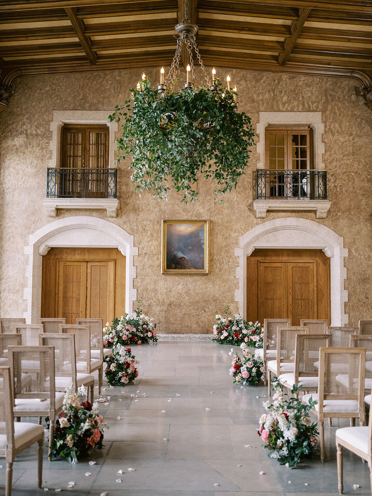 Wedding ceremony space with beautiful florals in pink, white and red at the Banff Springs Hotel