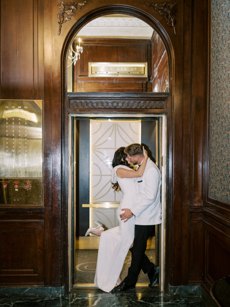 direct flash bride and groom kissing in elevator