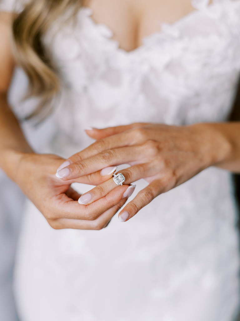 bride getting ready photo, putting wedding ring on hand