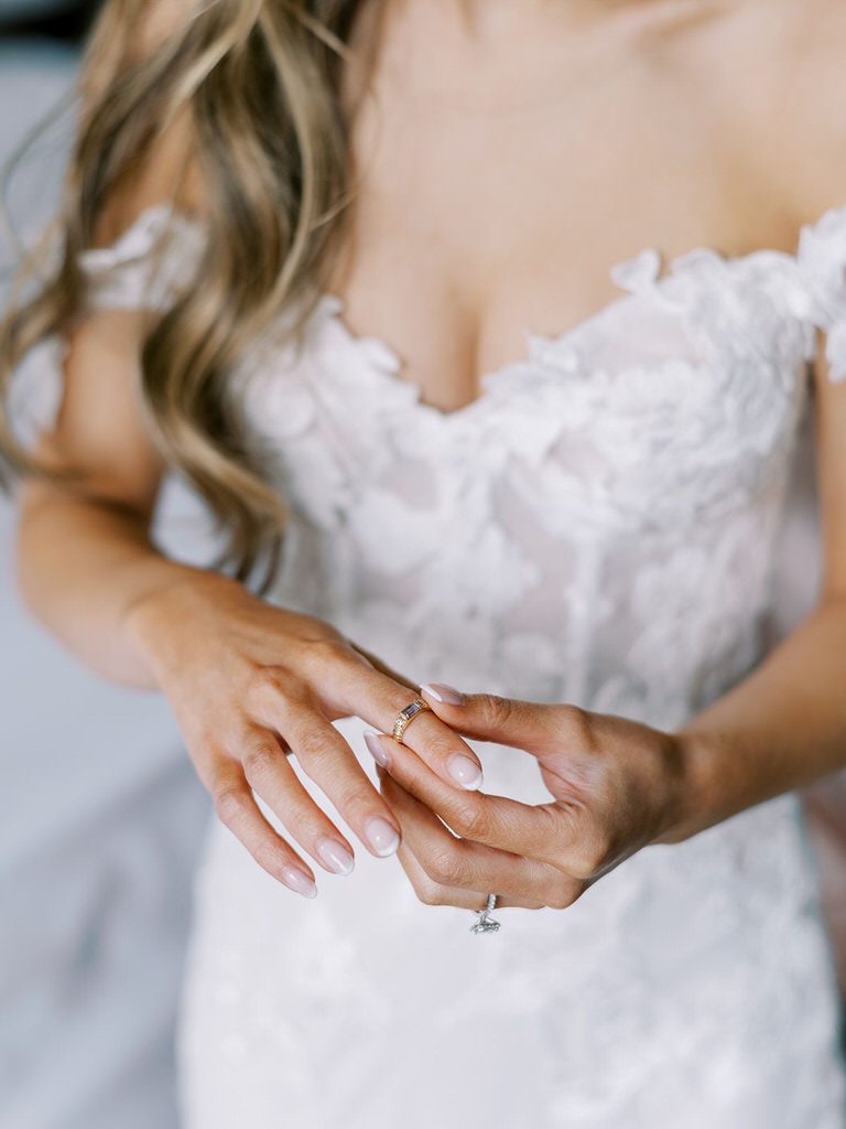 bride getting ready photo, putting wedding ring on hand