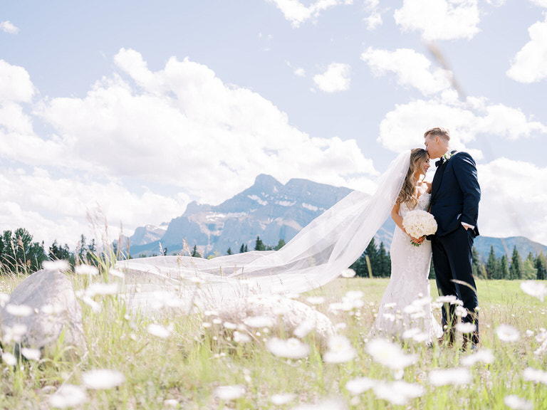 Bride and Groom wedding portrait in Canadian Rockies with wild flowers