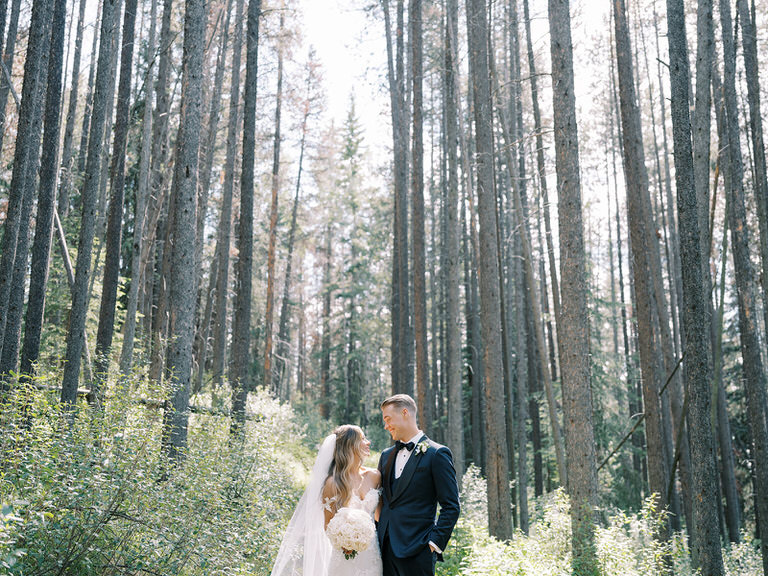 Bride and Groom wedding portrait in Canadian Rockies with forest and wild flowers