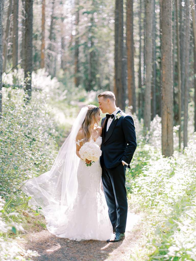 Bride and Groom wedding portrait in Canadian Rockies with forest and wild flowers