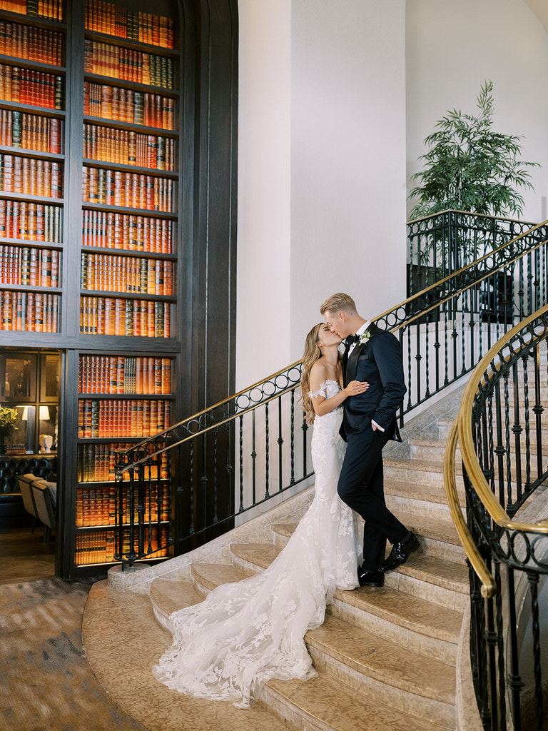 bride and groom wedding portrait on staircase of Fairmont Banff Springs Hotel