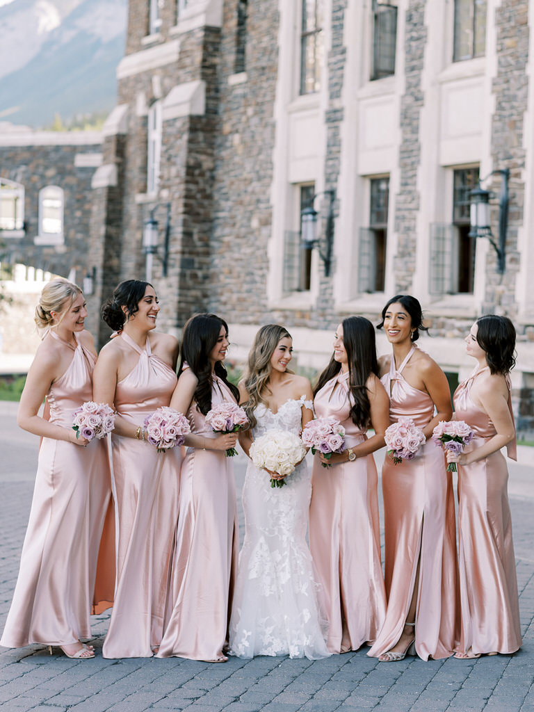bride and bridesmiads, Pink satin dresses with pink and white roses. 