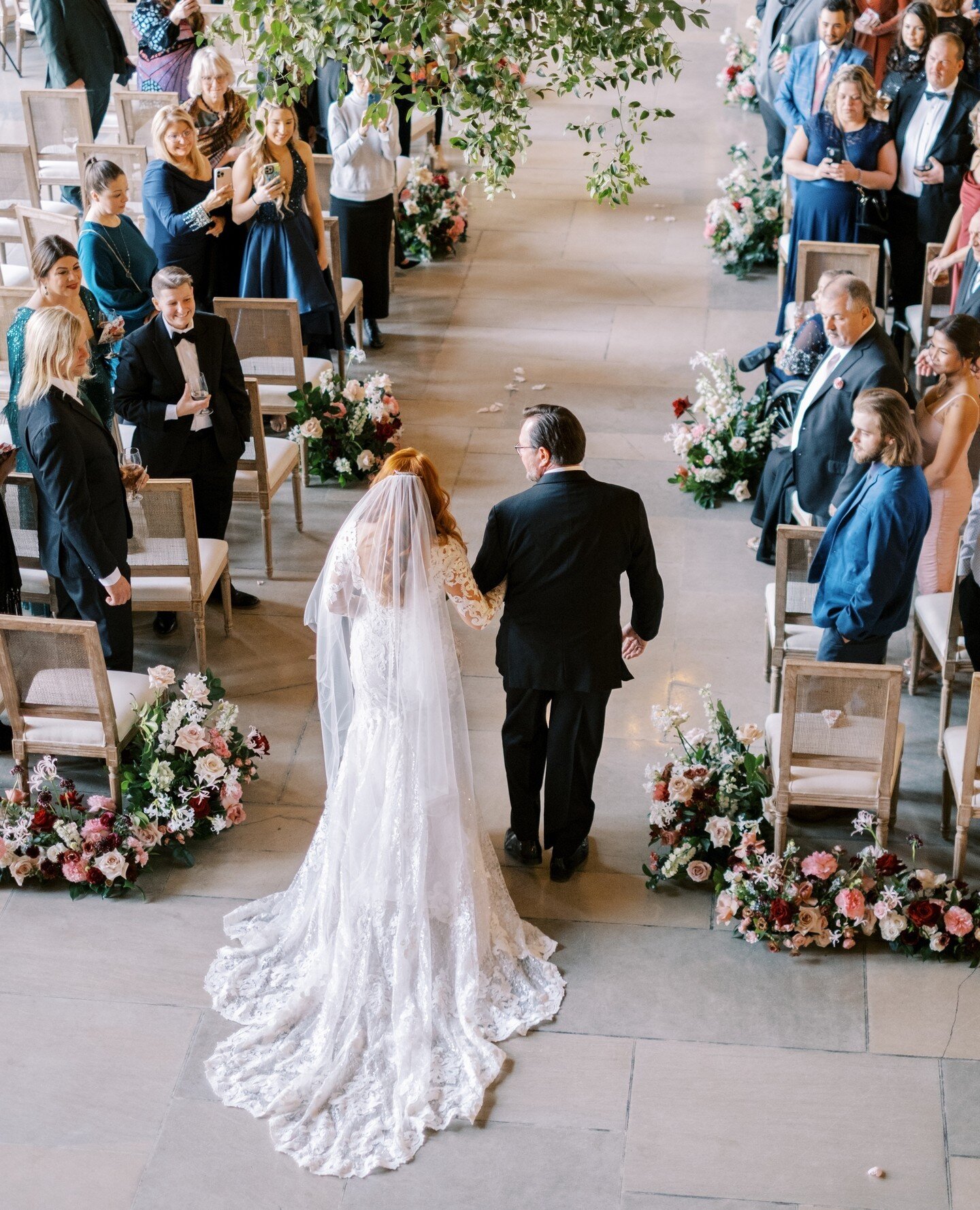 Which view do you prefer when walking down the aisle? The shot from the front with your expression or the shot from the back with the whole train and dress and decor and crowd?⁠
⁠
I love them both, I usually try to capture both if I (or Alan) can a