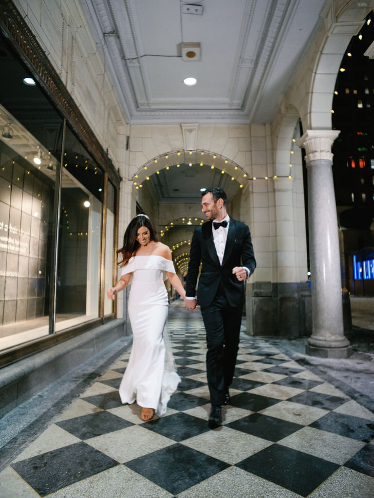 Portrait of Bride and Groom holding hands - Downtown editorial style wedding photography