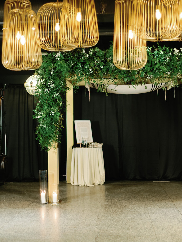 Tradirional jewish ceremony canopy - chuppah - with green foliage and gold accents