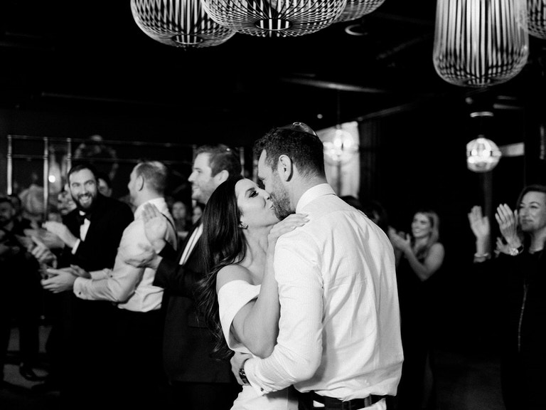 Bride and Groom kissing during the Hora. Balck and white wedding photography