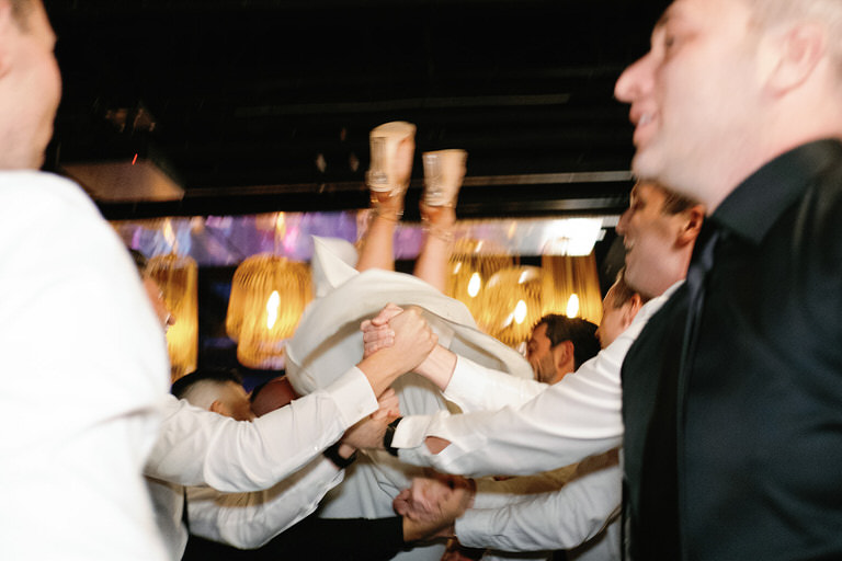 Bride being lifted during the Hora