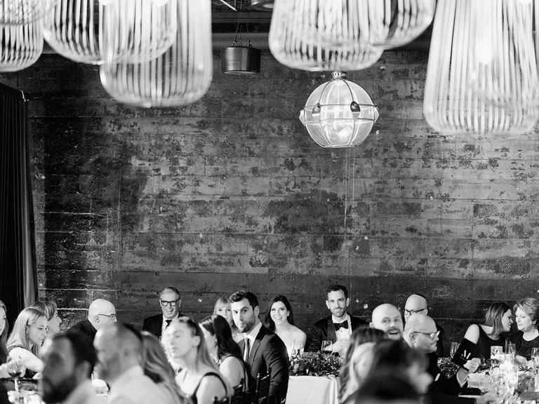 Jewish wedding reception, bride and groom at head table, black and white