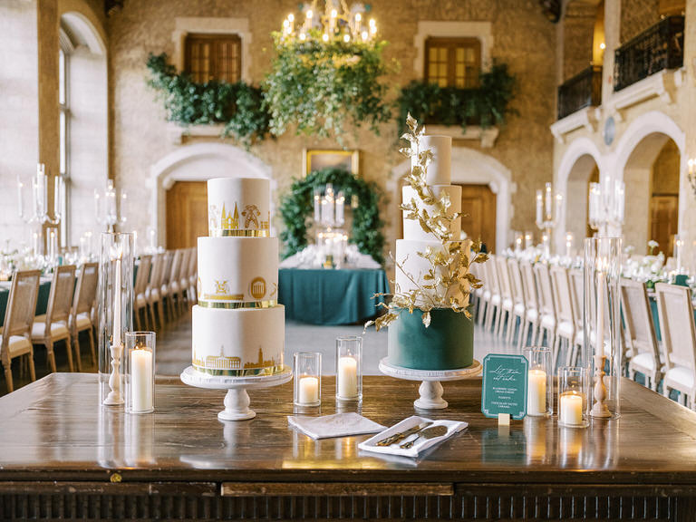 Wedding details of reception with dark accents, gold accents, wedding cake, place settings, green folliage white florals at Fairmont Banff Springs, Banff National Park 