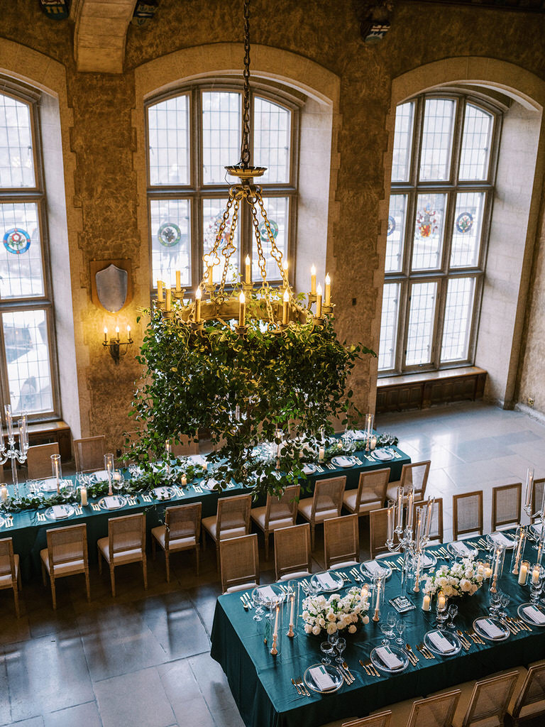 Wedding details of reception with dark accents, gold accents, green foliage and white florals at Fairmont Banff Springs, Banff National Park 