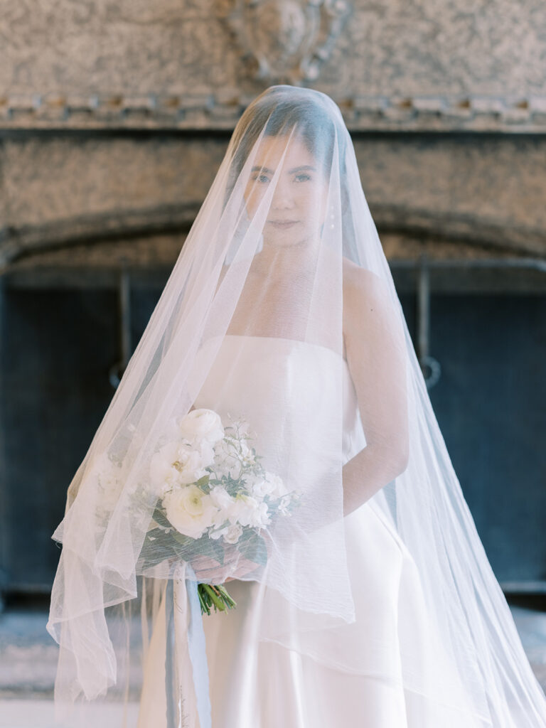 bridal portrait, bride with veil, white floral bouquet. 