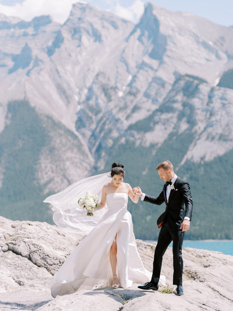 Bride and Groom couples portrait, white floral bouquet, with the Canadian Rocky Mountains in the background