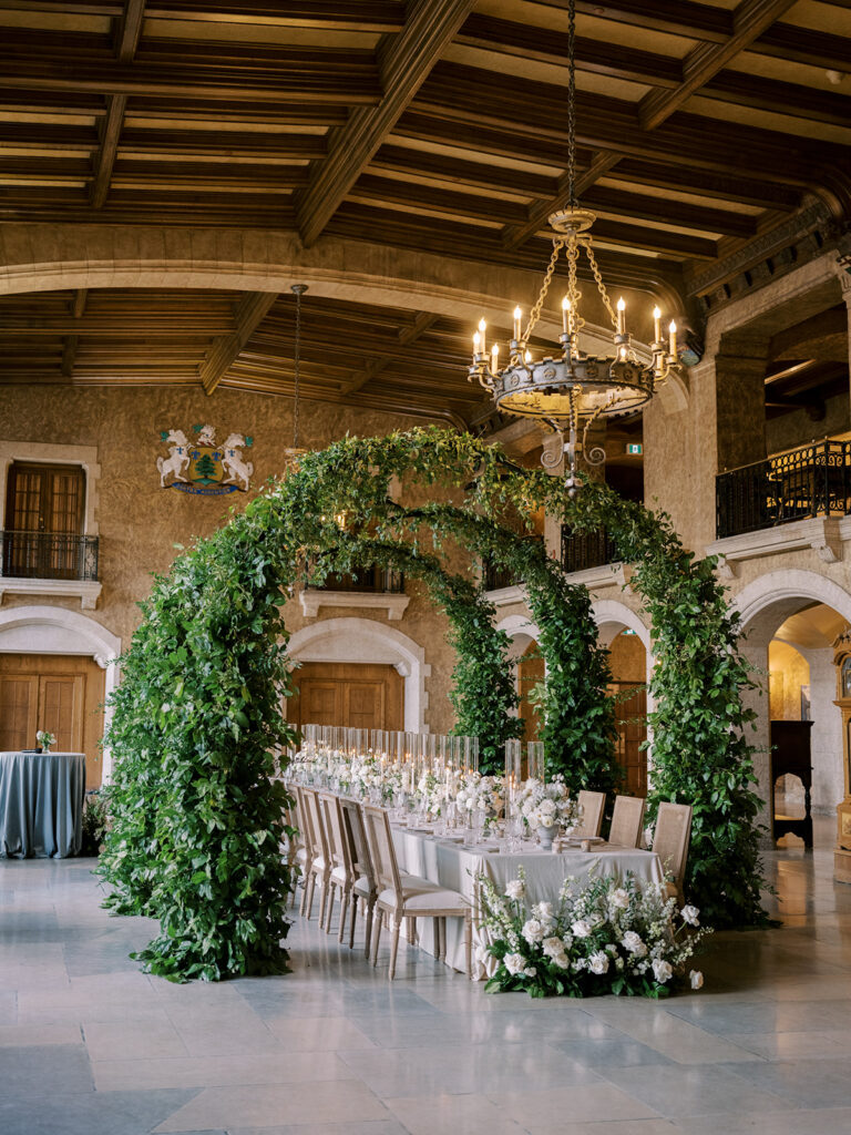 wedding reception with green arches, white florals and light blue details inside the ballroom of the Banff Springs Hotel Fairmont