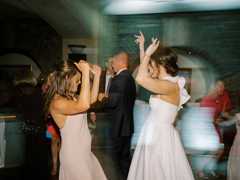 wedding reception dance floor, motion blur photo. Bride and maid of honour on dance floor. 