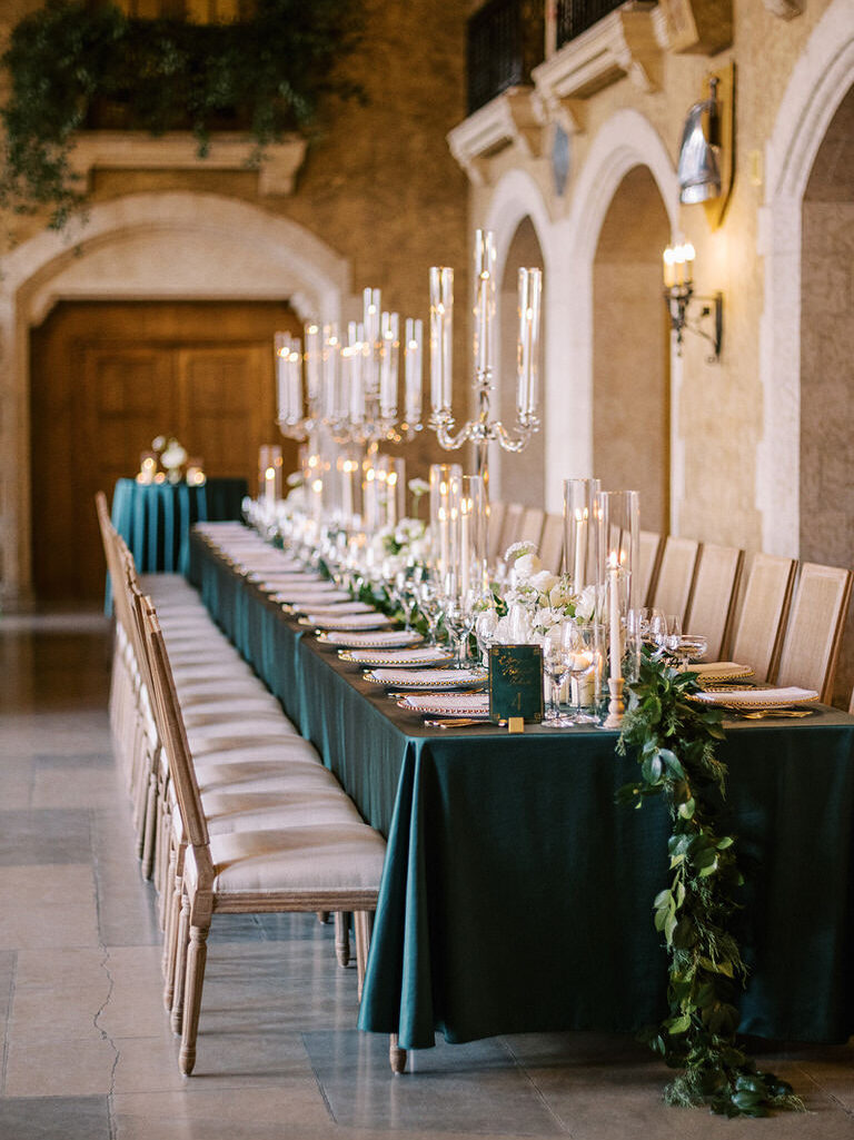 Wedding details of reception with dark accents, gold accents, green foliage and white florals at Fairmont Banff Springs, Banff National Park 