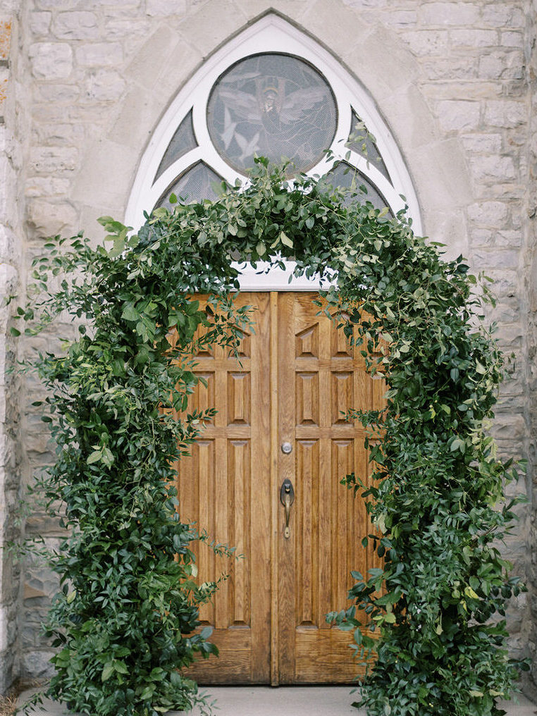 Archway of church with green florals, Banff, Canada 