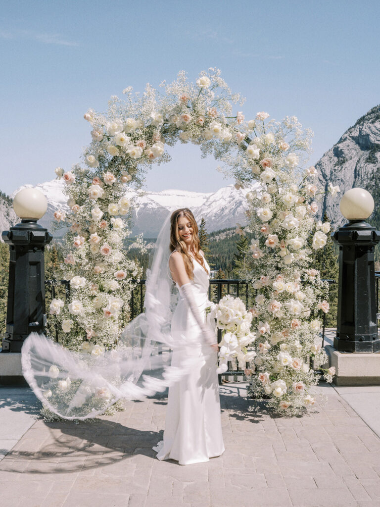 Bride with long gloves and lace veil motion blur film photography at the Fairmont Banff Springs captured by Banff wedding photographer Justine Milton