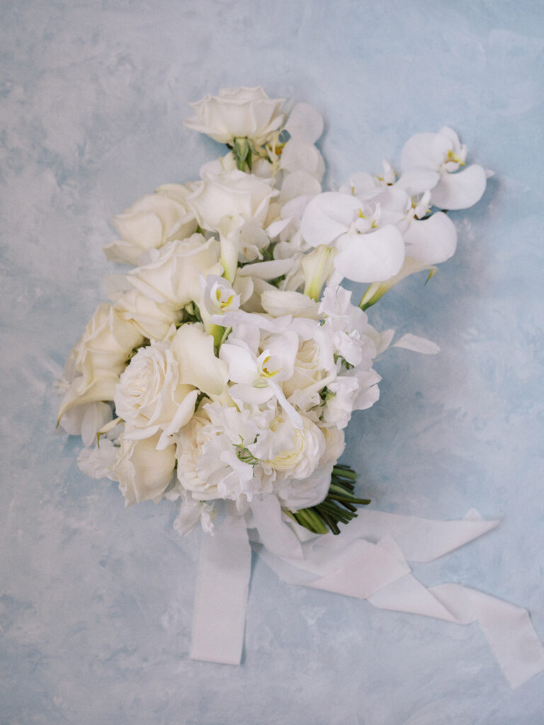 modern cool girl wedding bouquet with all white florals and orchids captured by Banff wedding photographer Justine Milton
