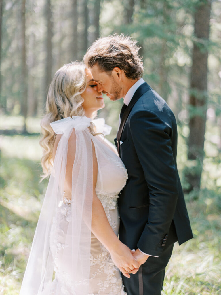 bride and groom in forrest in Banff National Park captured by Banff Wedding Photographer Justine Milton