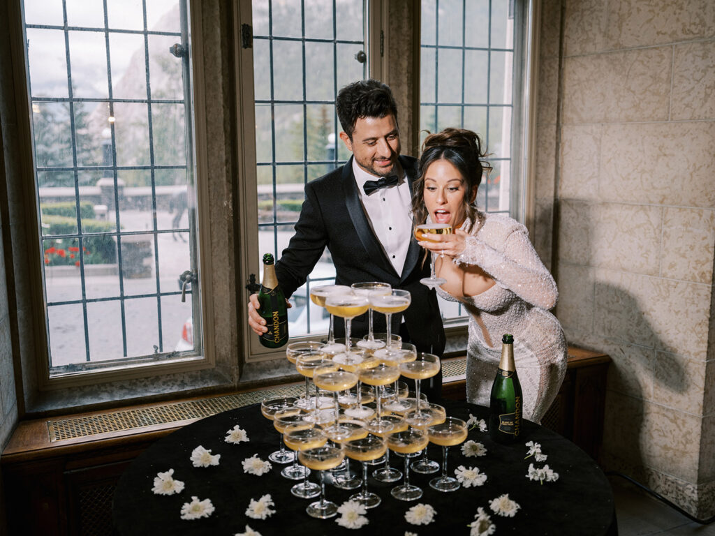 Bride and groom enjoy the champagne tower.