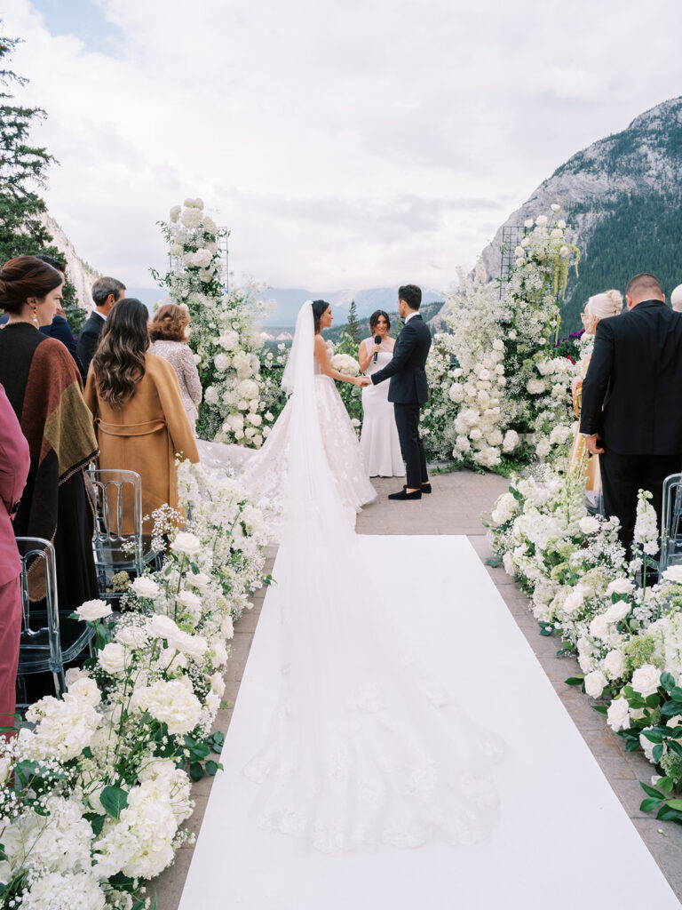 Banff Springs wedding ceremony on the terrace. Filled with lush white floral arrangements.