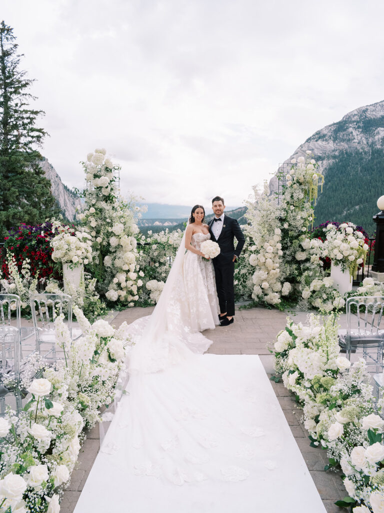 Bride and groom on the terrace of the Fairmont Banff Springs hotel.