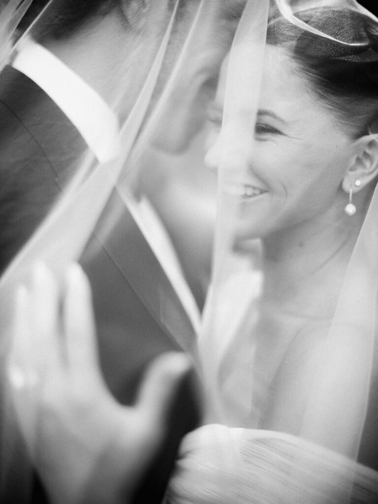 black and white film photograph of happy bride, Tasha and groom, Chandler Stephenson captured by Canadian and destination wedding photographer Justine Milton